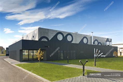 Modern Factory Building Exterior — trees, lighting - Stock Photo | #412508020