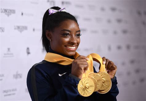 Gymnast Simone Biles Flaunts Her Enviable Figure in Red Swimsuit by the Pool in a New Picture