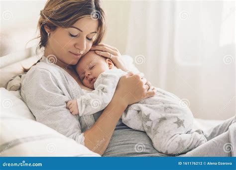 Loving Mom Carying of Her Newborn Baby at Home Stock Photo - Image of ...