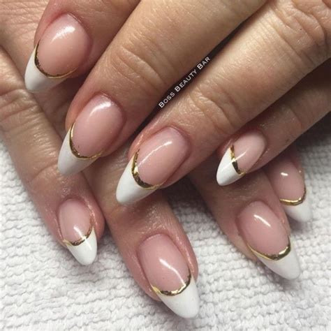 french manicure with gold details, on two pale hands, with medium to short pointy nails | French ...