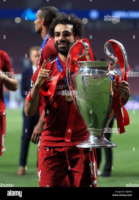 Liverpool's Mohamed Salah celebrates with the trophy after winning the ...