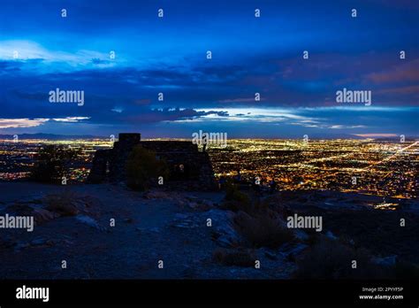 Night photograph of the silhouette of a man standing on the roof of Dobbins Lookout, watching ...