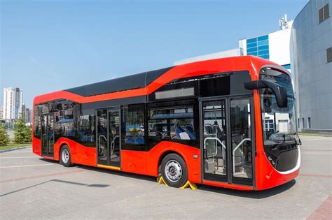 Premium Photo | Red modern city bus at the bus station on a clear day