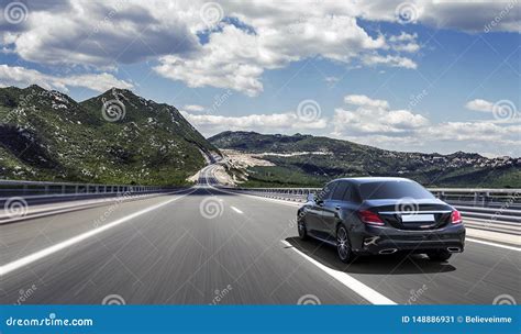 Car Drives Fast on a Highway in the Highlands. Stock Image - Image of ...