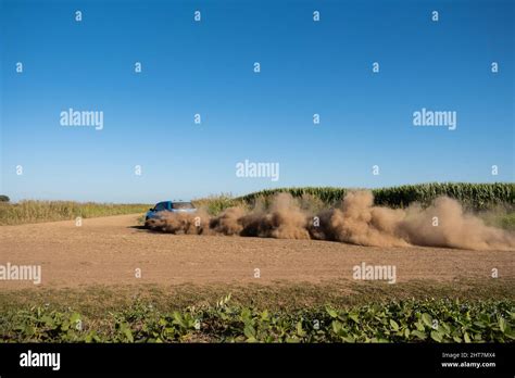 Rally car raising dust while racing on a desert Stock Photo - Alamy