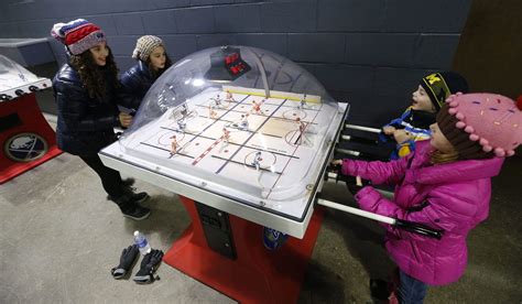 Children play a game of bubble hockey inside RiverWorks during the 2016 Labatt Blue Pond Hockey ...