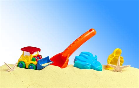 Premium Photo | Colorful toys for child sandboxes against the beach sand