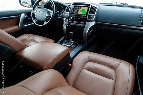 View to the interior of Toyota Land Cruiser 200 with dashboard, clock, media system, front seats ...