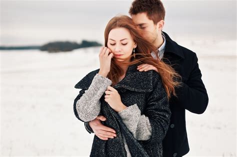 Lovely boyfriend hugging his girlfriend on a windy day Photo | Free ...