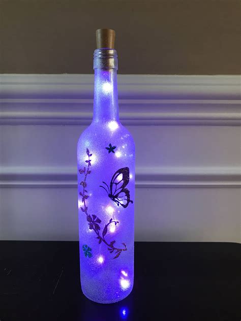 I repurposed this wine bottle into a light. It is covered with some light paint and glitter. It ...