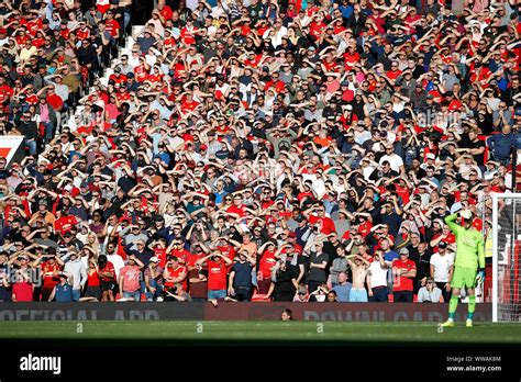 Manchester United fans shield their eyes from the sun during the ...