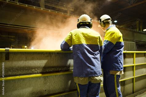 workers of a steel factory look at the manufacturing process Stock ...