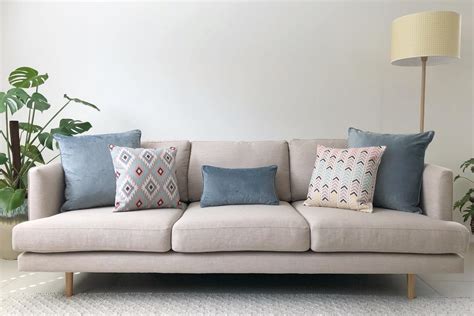 Grey sofa with soft blue and grey cushions