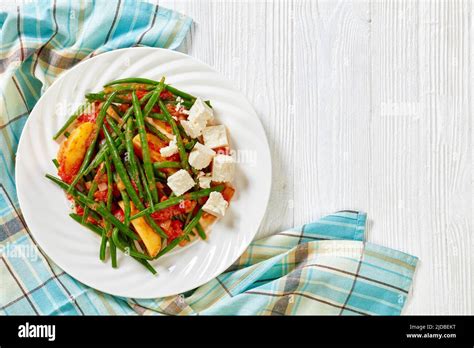 fasolakia lathera, green beans, onion and potatoes stewed in tomato, herbs and olive oil on ...