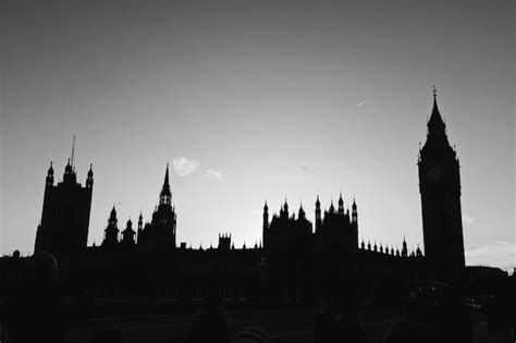 Premium Photo | Silhouette of clock tower in city