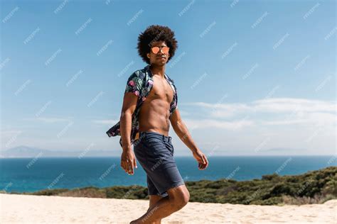 Free Photo | Handsome african american man walking on beach