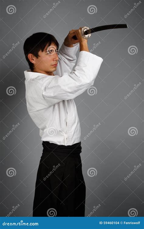 Man In Aikido Uniform With Katana Sword Stock Photography | CartoonDealer.com #59460104