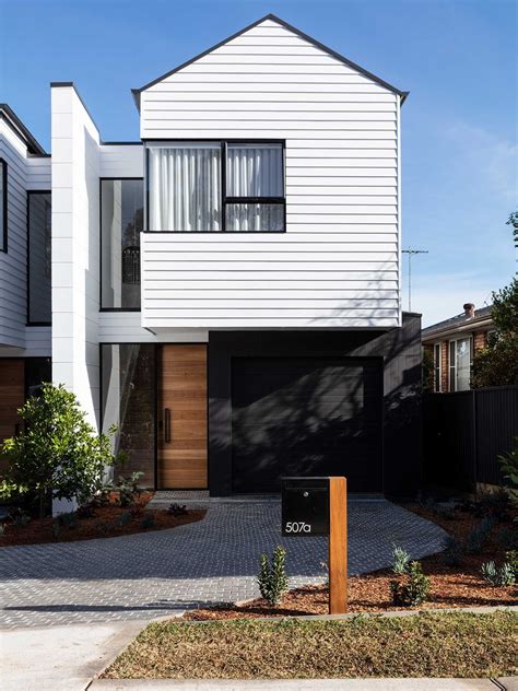 White colourbond home with timber door and tiled driveway. | Facade house, Townhouse exterior ...