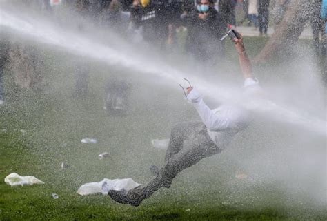 Man protesting Covid restrictions in Belgium hit by water cannon. - 9GAG