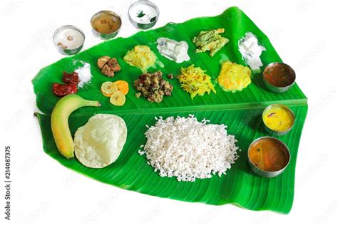 Traditional Onam Feast or Onasadya served in Banana leaf isolated on white Stock Photo | Adobe Stock