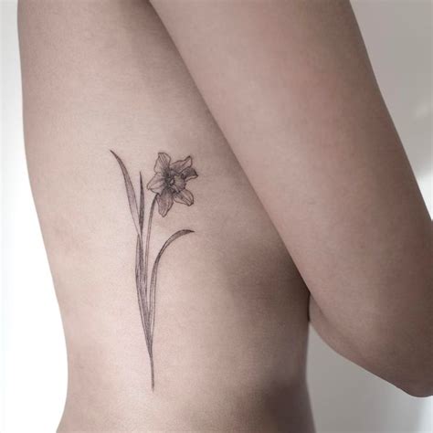 Delicate black daffodil tattoo along the rib cage. #daffodil #flowertattoo | Daffodil tattoo ...