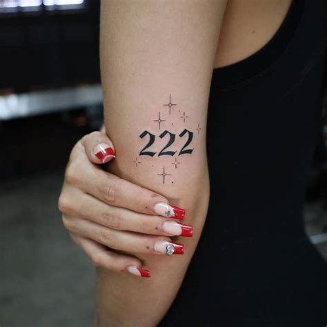 Tattoo of the number "222" located on the tricep.