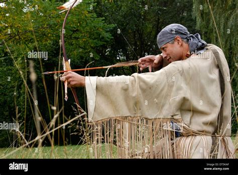 Native American Indian man with a bow and arrow hunting Stock Photo - Alamy