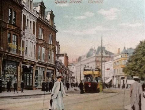 an old photo of people walking down the street