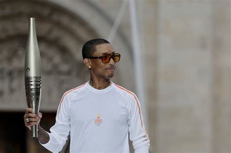 Pharrell Williams Carries Torch at Paris 2024 Olympics | Pitchfork