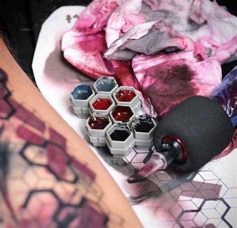 Skateboarder's Leg with Tattoos and Ink Bottles