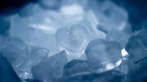 some ice cubes are sitting on top of each other in the dark blue light