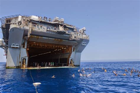 Sailors and Marines from the multipurpose amphibious assault ship USS Bataan (LHD 5) participate ...