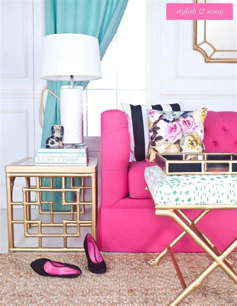 a living room with pink couch, gold side table and black and white ...