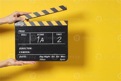 Hand holding clapper board concept, creative photo of blackboard for film making industry ...