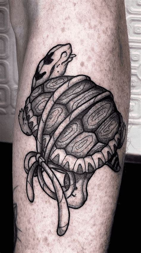 a man's leg with a black and white drawing of a crab on it