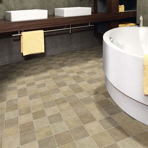 Our vinyl floor has square shaped blocks in varied hues that resemble ...