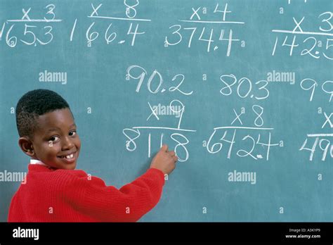 African American male student solving math problems on chalk board in Stock Photo: 6178728 - Alamy