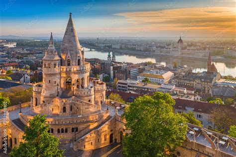 Budapest, Hungary - Beautiful golden summer sunrise with the tower of Fisherman's Bastion and ...