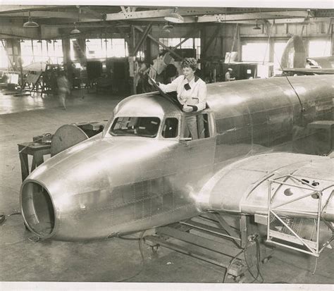 Amelia Earhart standing in the cockpit of of the Lockheed Electra 10E under construction 1936 3 ...