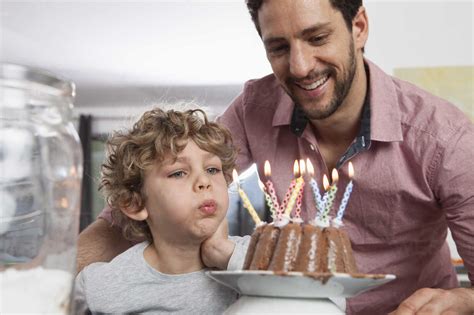 Father and son with birthday cake stock photo