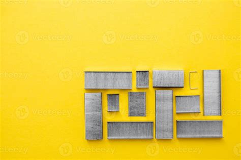 Metal staples for stapler on yellow background 4718225 Stock Photo at Vecteezy