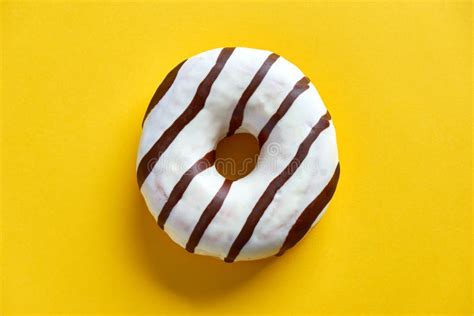 Single Donut On A Shiny White Plate Against Yellow Background Stock ...