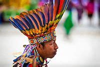 A Colombian Kamentsá native, wearing a colorful feather headgear, takes ...