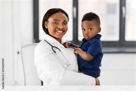 medicine, healtcare, pediatry and people concept - happy african american female doctor or ...