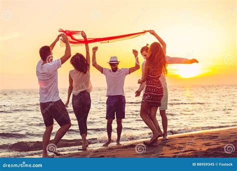 Group of Happy Young People is Running on Background of Sunset Beach and Sea Stock Image - Image ...