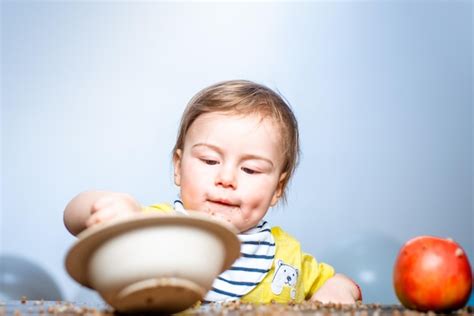 Premium Photo | Cute funny babies eating baby food funny kid boy with ...