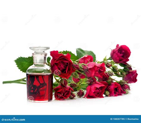 Rose Essential Oil in a Glass Bottle and Flowers Roses Stock Image ...