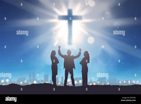 Silhouette of three people looking christian cross on the sky. Religion concept Stock Photo - Alamy