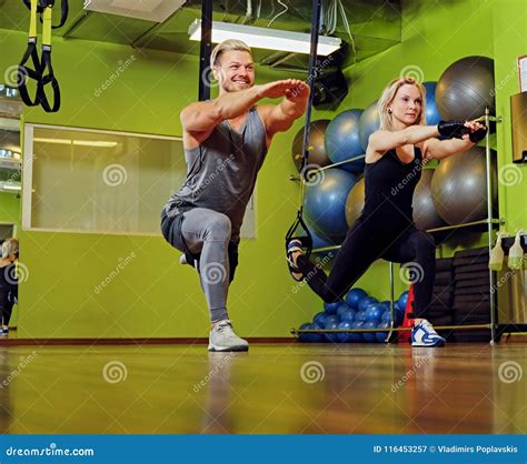 Sporty Male and Female Doing Trx Straps Exercises in a Gym Club. Stock ...