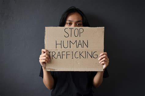 Premium Photo | Stop human trafficking woman holding a board with stop ...